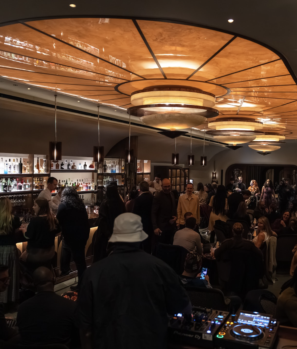 Warm amber interior of Gambit Bar, the underground cocktail den at The Newman Hotel on Newman Street, Fitzrovia