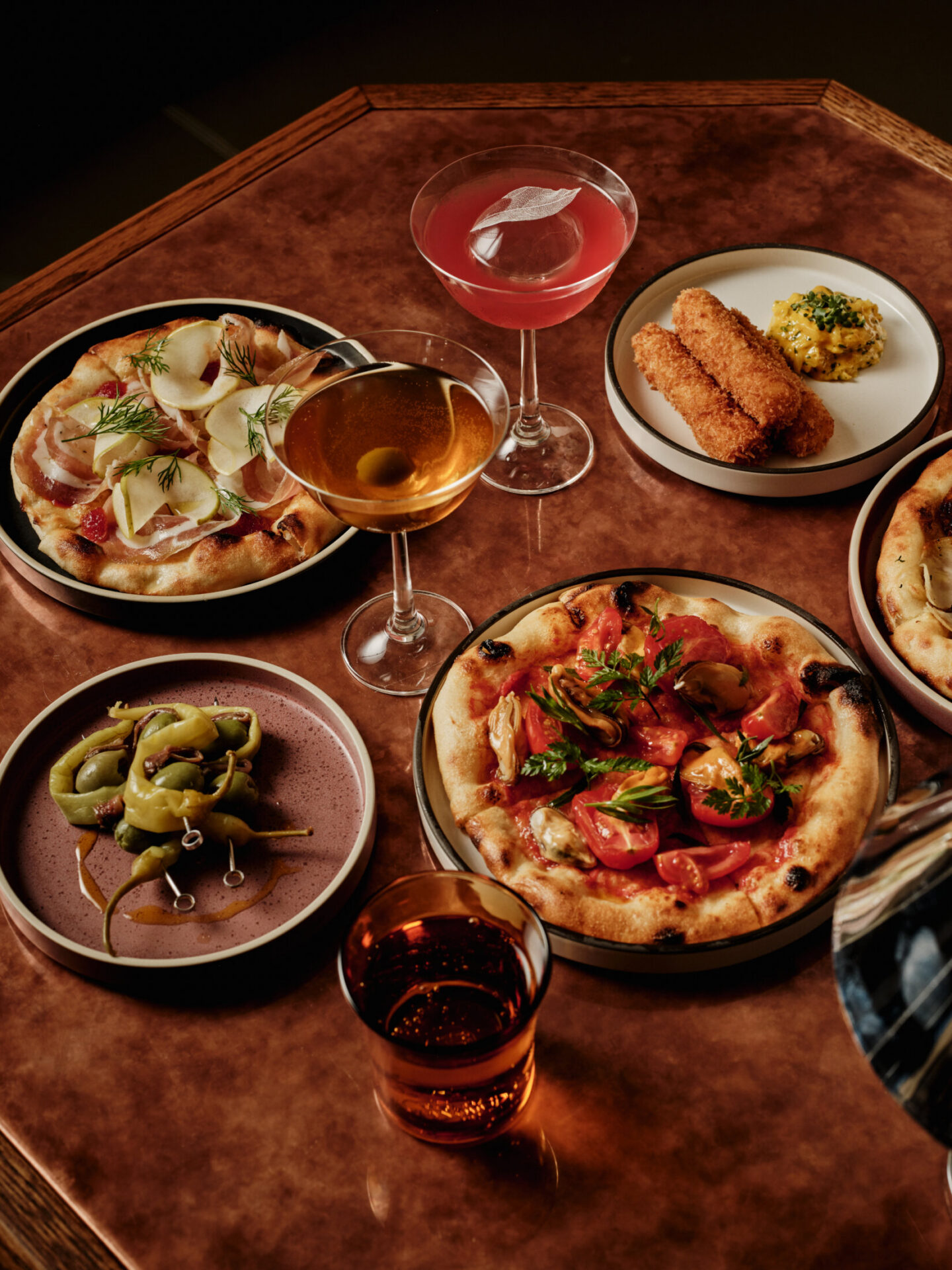 Artisan pizza and craft cocktails served at the copper bar inside Gambit Bar at The Newman Hotel, Fitzrovia