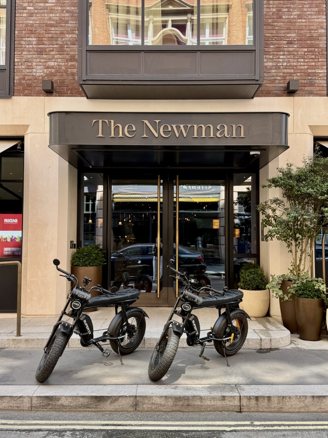Two electric bikes outside The Newman Hotel